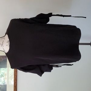 May May, black top with large, gathered sleeves.